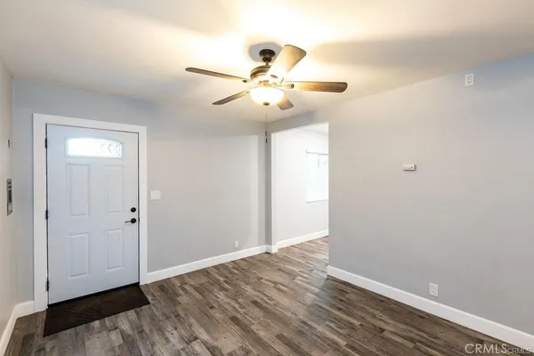 a view of an empty room with wooden floor