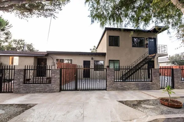 a view of a house with iron fence