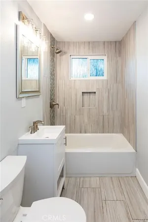 a bathroom with a sink a toilet and bathtub