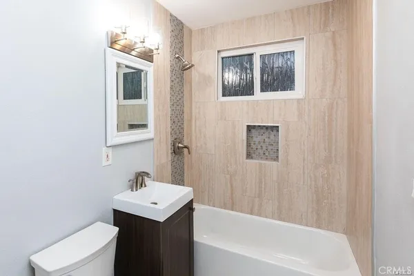 a bathroom with a sink a toilet and bathtub