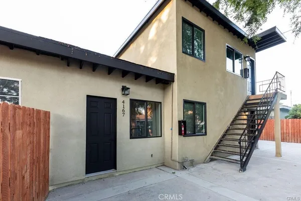a view of a house with entryway and wooden wall