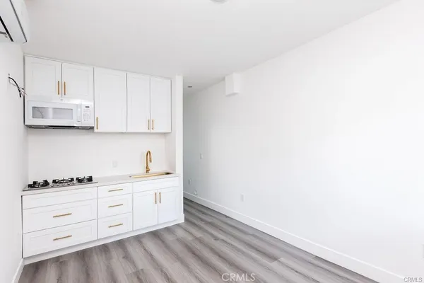 a kitchen with white cabinets and a stove