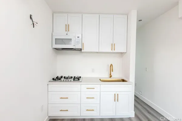 a kitchen with cabinets appliances and a window