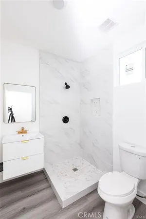 a bathroom with a shower sink and toilet