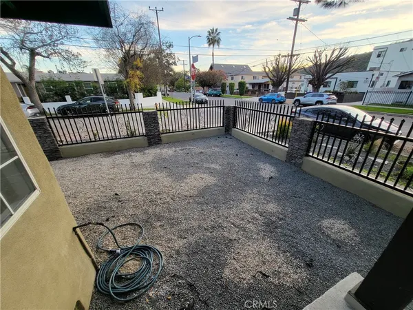 a view of a yard with wooden fence