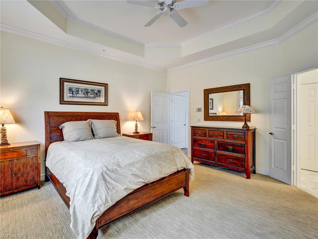 210 2nd Street South, Unit 1C Naples, FL 34102 - Photo 12 of 28 a bedroom with a bed and a chandelier