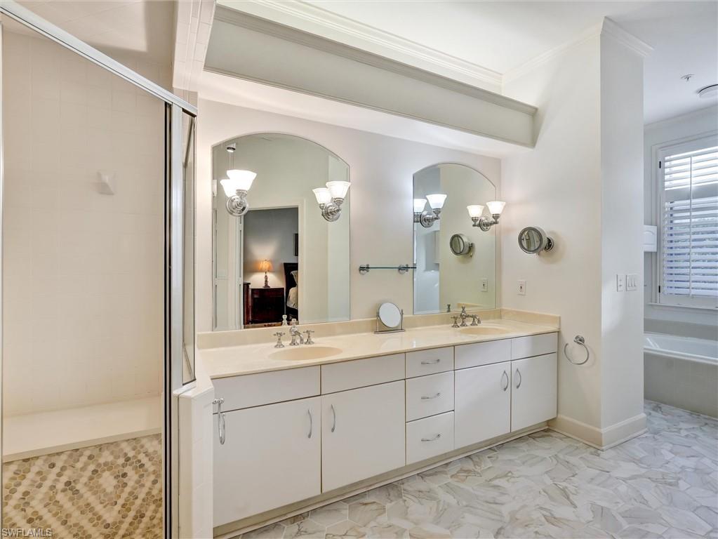 210 2nd Street South, Unit 1C Naples, FL 34102 - Photo 13 of 28 a bathroom with a double vanity sink and a mirror