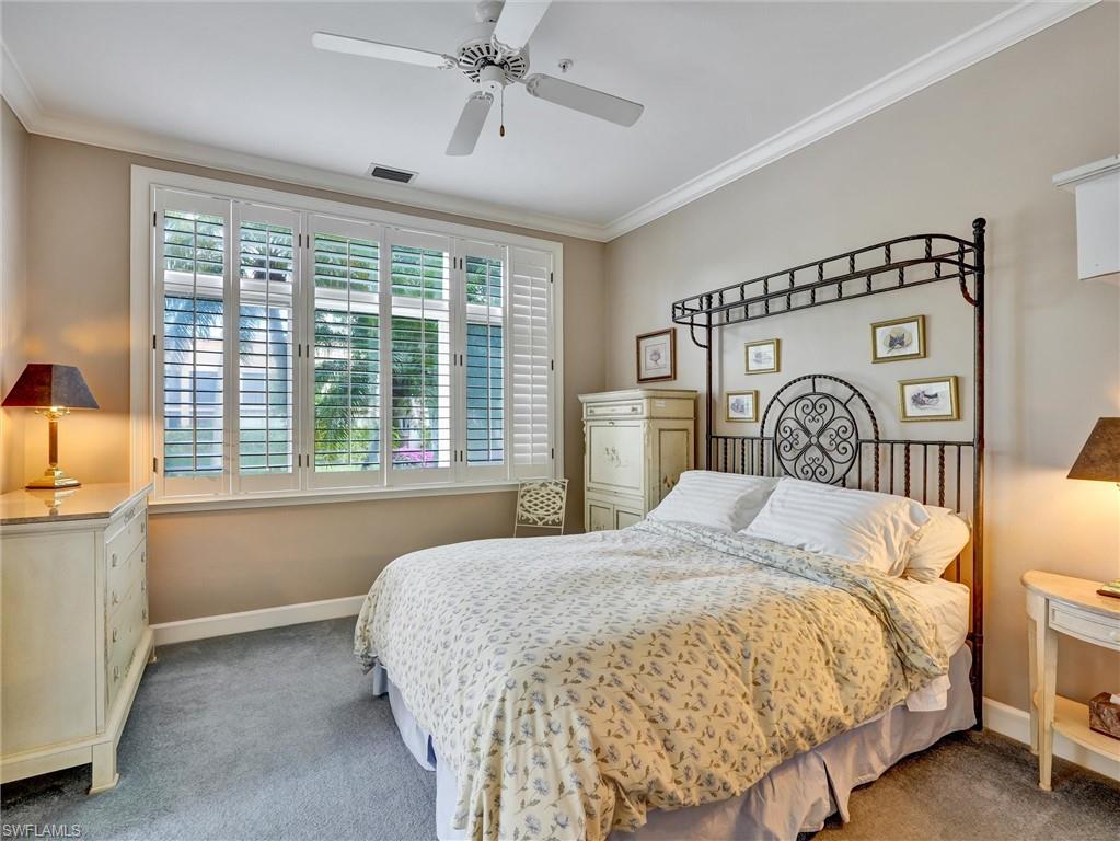 210 2nd Street South, Unit 1C Naples, FL 34102 - Photo 17 of 28 a bedroom with a bed and a large window