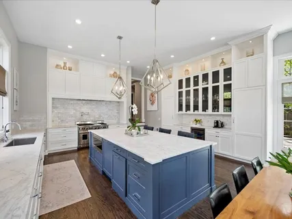 a kitchen with stainless steel appliances white cabinets and a window