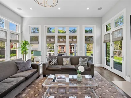 a living room with lots of furniture and a chandelier