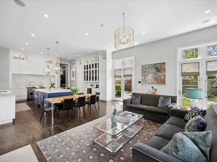 a living room with furniture large window and a fireplace