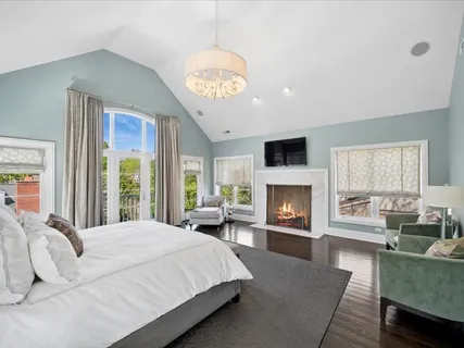 a bedroom with furniture and a large window