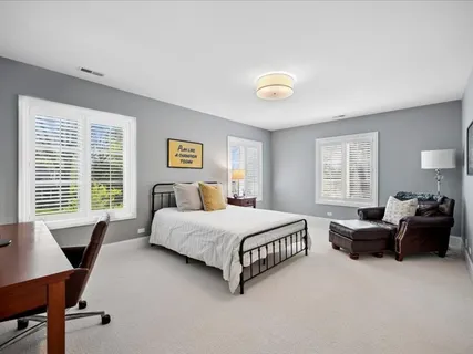 a spacious bedroom with a bed and a couch