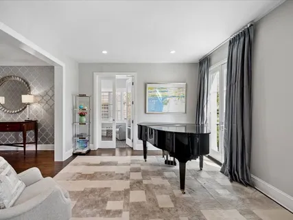 a living room with furniture a large mirror and a table