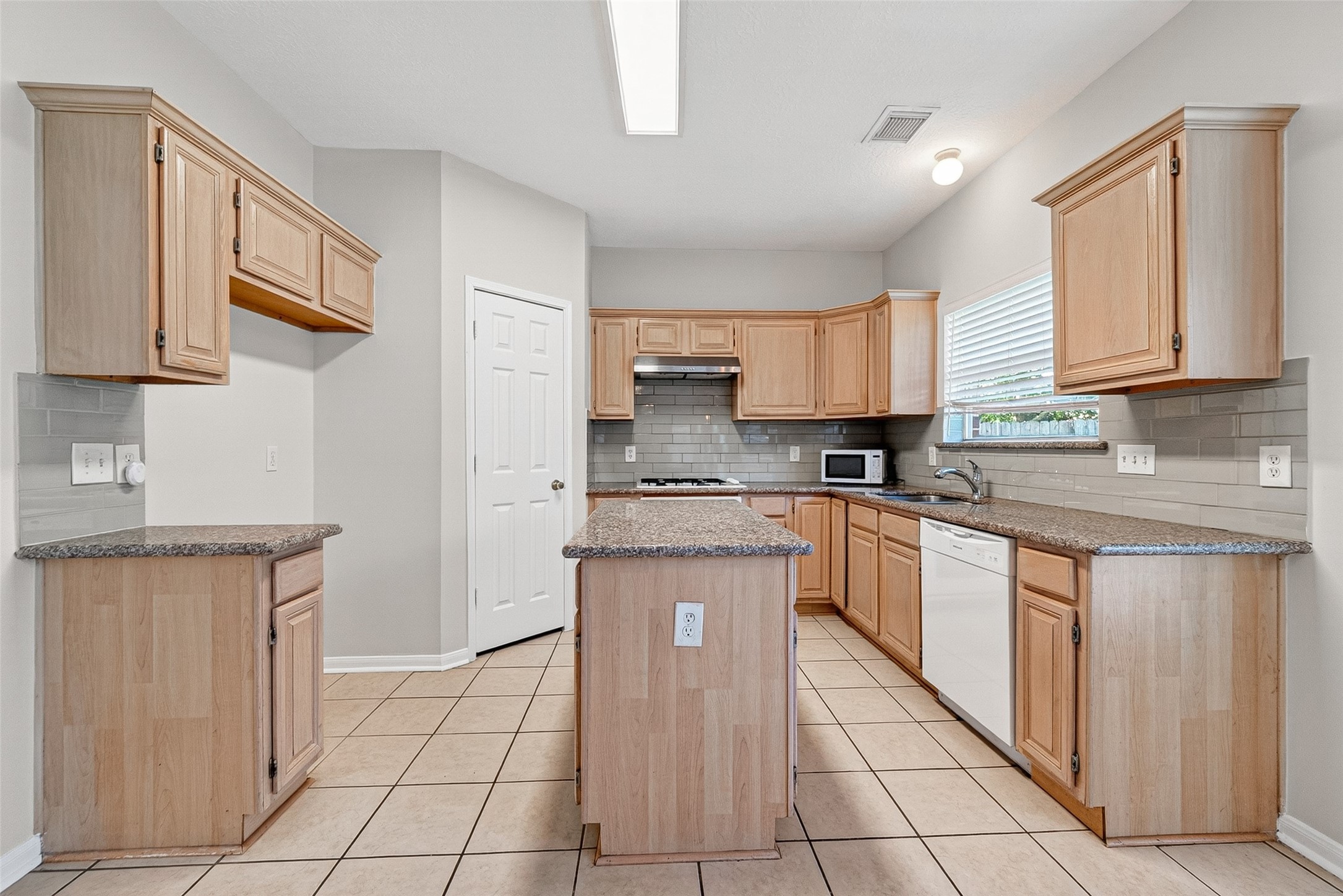 4539 Springfield Lakes Street Sugar Land, TX 77479 - Photo 10 of 34 a kitchen with stainless steel appliances granite countertop a sink and cabinets