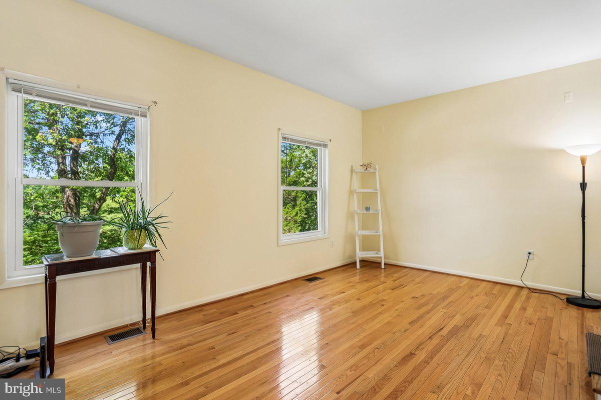 76 Timber Rock Road Gaithersburg, MD 20878 - Photo 11 of 51 a view of an empty room with wooden floor and a window