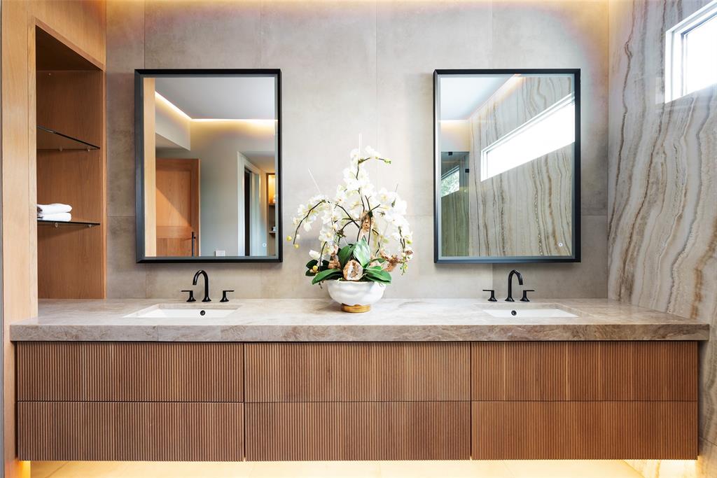 9435 Inwood Road Dallas, TX 75220 - Photo 24 of 37 a bathroom with double vanity sinks and a mirror