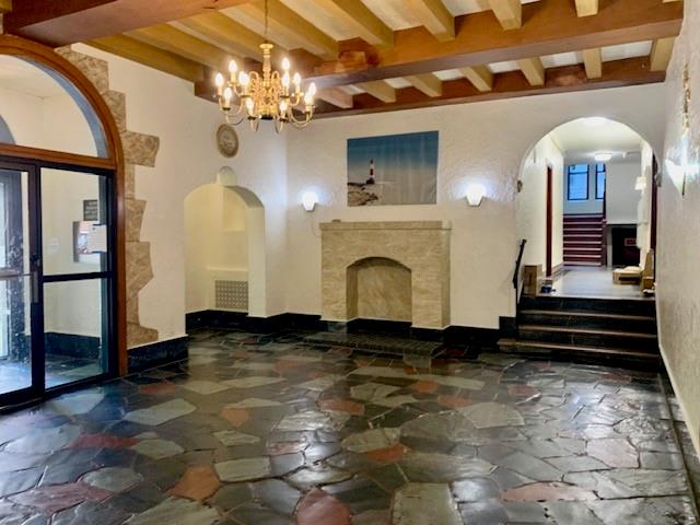 255 79th Street, Unit E8 Brooklyn, NY 11209 - Photo 3 of 9 a living room with fireplace furniture and a chandelier