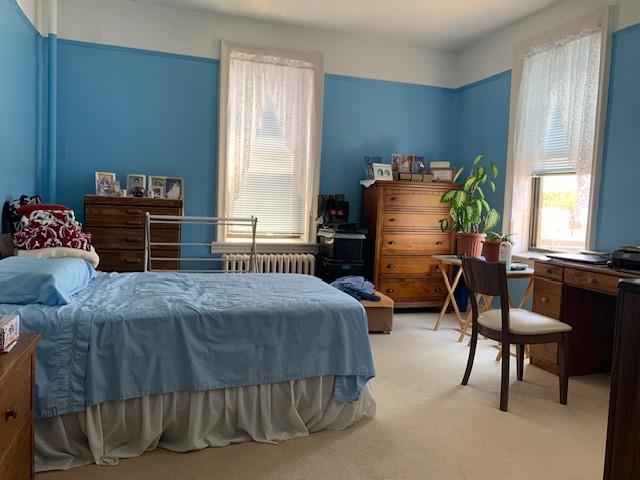 255 79th Street, Unit E8 Brooklyn, NY 11209 - Photo 5 of 9 a bedroom with a bed and a chandelier
