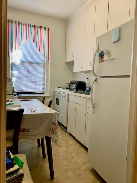 255 79th Street, Unit E8 Brooklyn, NY 11209 - Photo 6 of 9 a kitchen with a sink a stove and a refrigerator