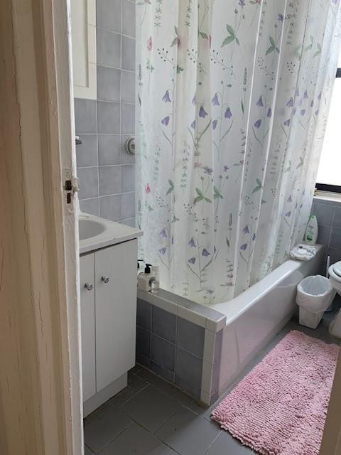 255 79th Street, Unit E8 Brooklyn, NY 11209 - Photo 8 of 9 a bathroom with a bathtub and sink