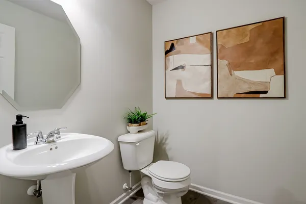 a bathroom with a sink mirror and toilet