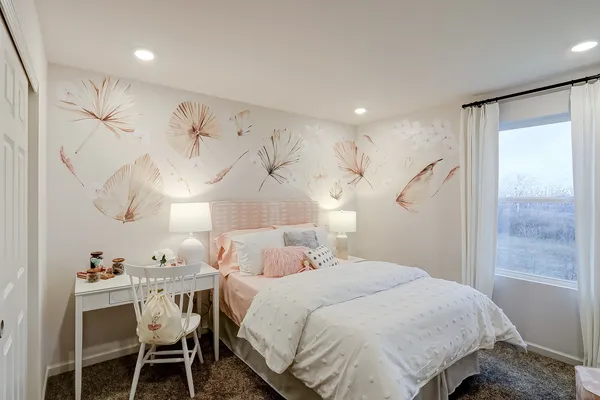 a bedroom with a bed and a table in it