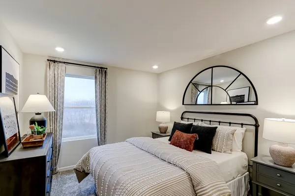 a bedroom with a bed and a mirror