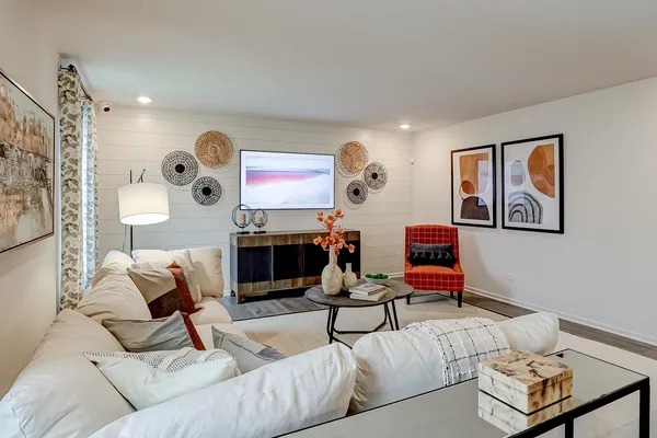 a living room with furniture and wooden floor