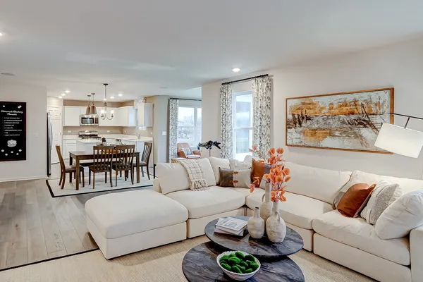 a living room with furniture and kitchen view