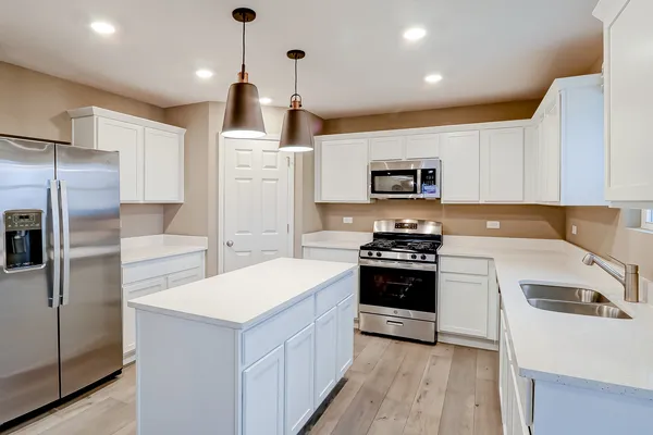 a kitchen with a sink a stove and refrigerator