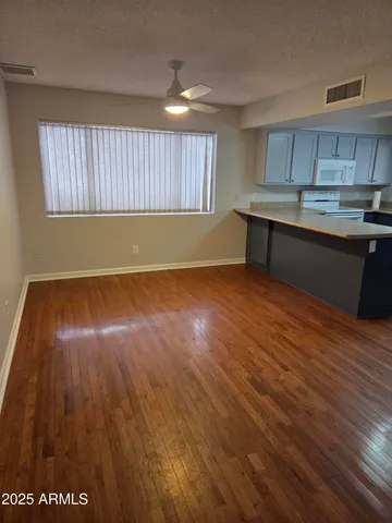 a view of kitchen with wooden floor and window