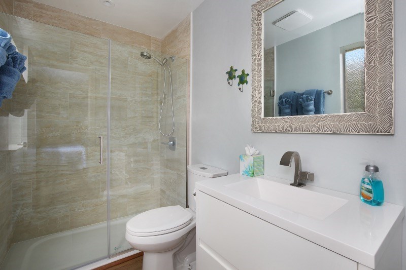 1697 Pe'e Road, Unit 104 Koloa, HI 96756 - Photo 11 of 17 a bathroom with a sink a toilet and shower