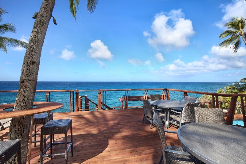 1697 Pe'e Road, Unit 104 Koloa, HI 96756 - Photo 14 of 17 a view of a chairs and table in the terrace