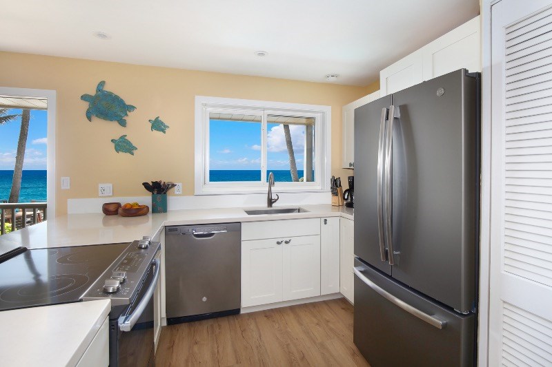 1697 Pe'e Road, Unit 104 Koloa, HI 96756 - Photo 3 of 17 a kitchen with a refrigerator sink and stove