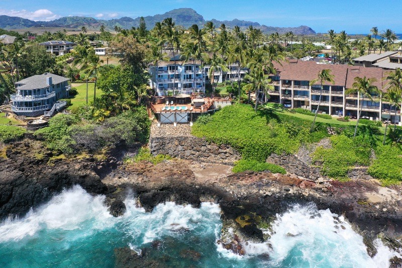 1697 Pe'e Road, Unit 104 Koloa, HI 96756 - Photo 4 of 17 a view of a lake with a building in the background