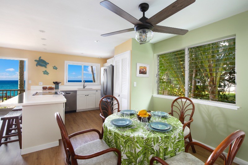 1697 Pe'e Road, Unit 104 Koloa, HI 96756 - Photo 6 of 17 a dining room with furniture a window and wooden floor