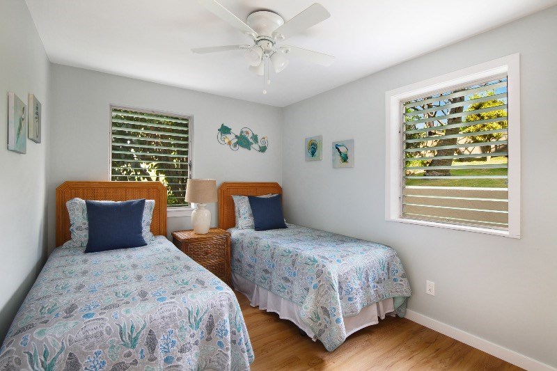 1697 Pe'e Road, Unit 104 Koloa, HI 96756 - Photo 10 of 17 a bedroom with two beds and a window