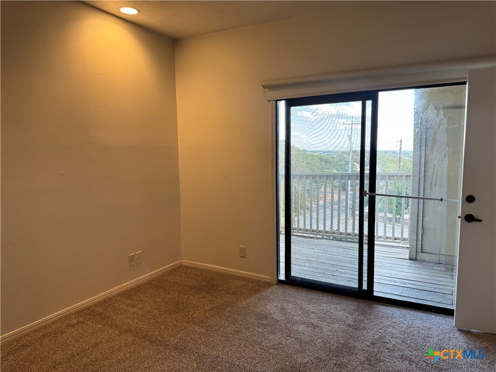1013 Chestnut Street, Unit D6 San Marcos, TX 78666 - Photo 7 of 13 an empty room with sliding door