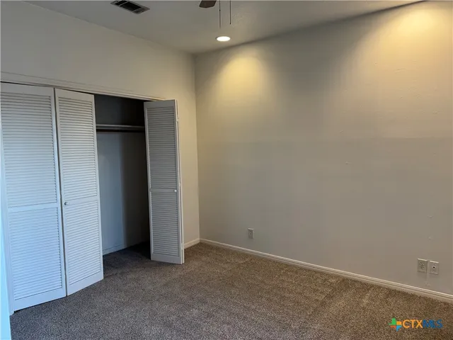 an empty room with closet area