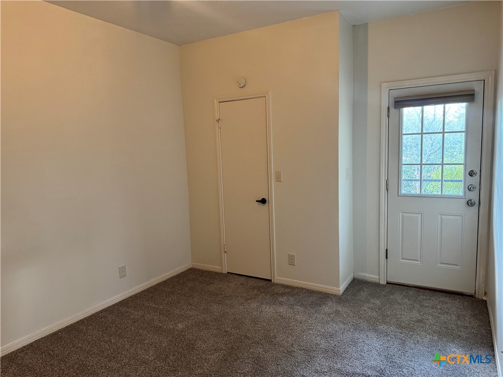 1013 Chestnut Street, Unit D6 San Marcos, TX 78666 - Photo 10 of 13 an empty room with windows