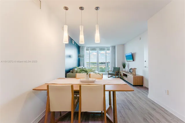 a dinning room with furniture and wooden floor