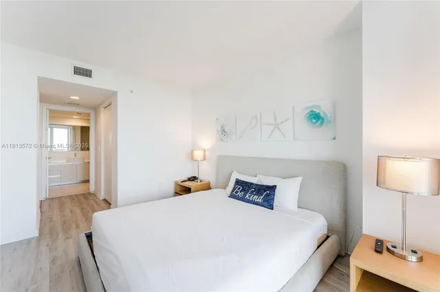 a bedroom with a bed and a lamp