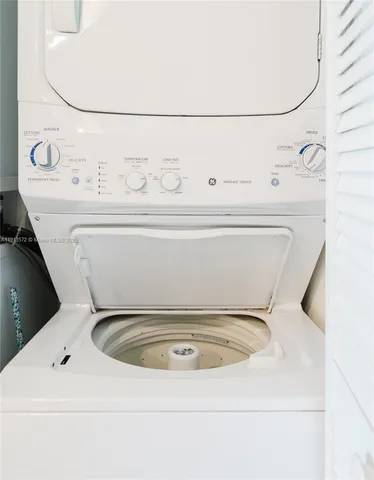 a utility room with a washer dryer and white walls
