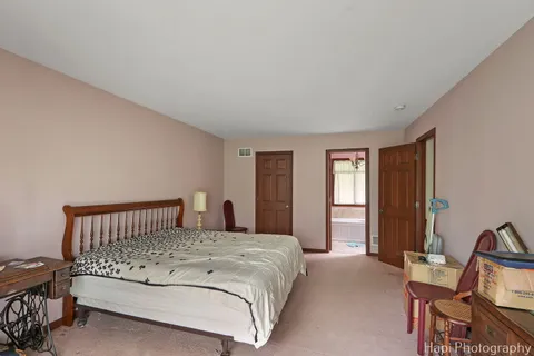 a bedroom with a bed and a chair