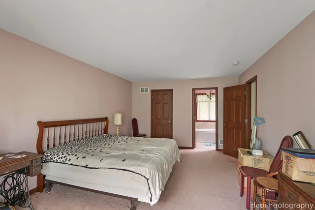 a bedroom with a bed and a chair