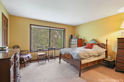 a bedroom with a bed and a large window