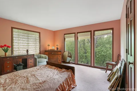 a bedroom with a bed and a large window