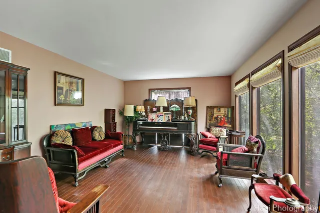a living room with furniture a rug and a large window