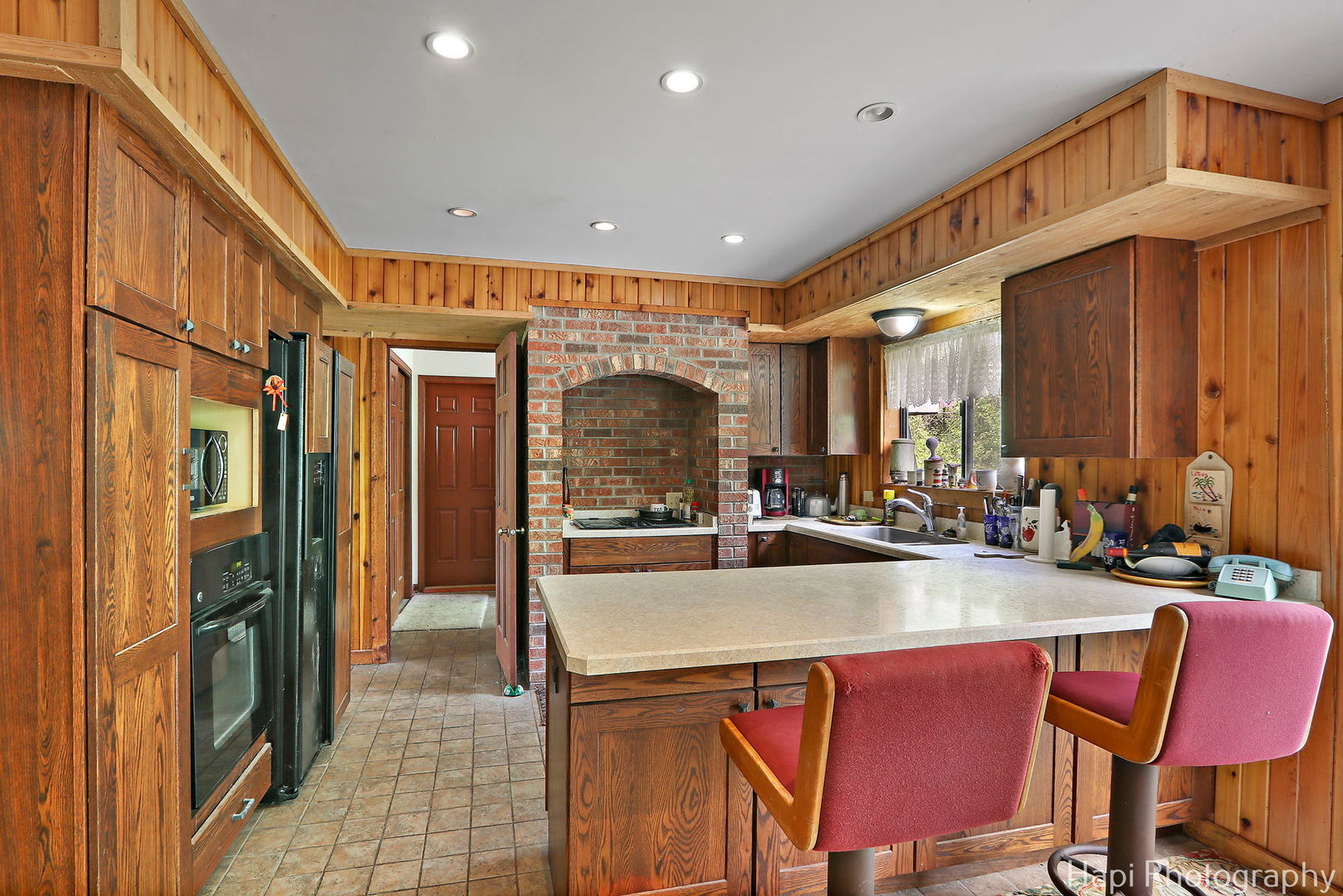 24570 West Middle Frk Road Barrington, IL 60618 - Photo 10 of 31 a kitchen with sink a refrigerator and chairs